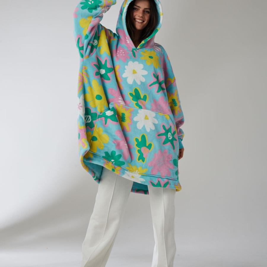 A female model wearing a snuggly floral hoodie