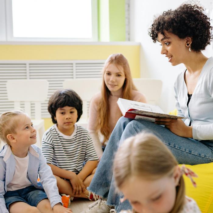 Woman reading to children
